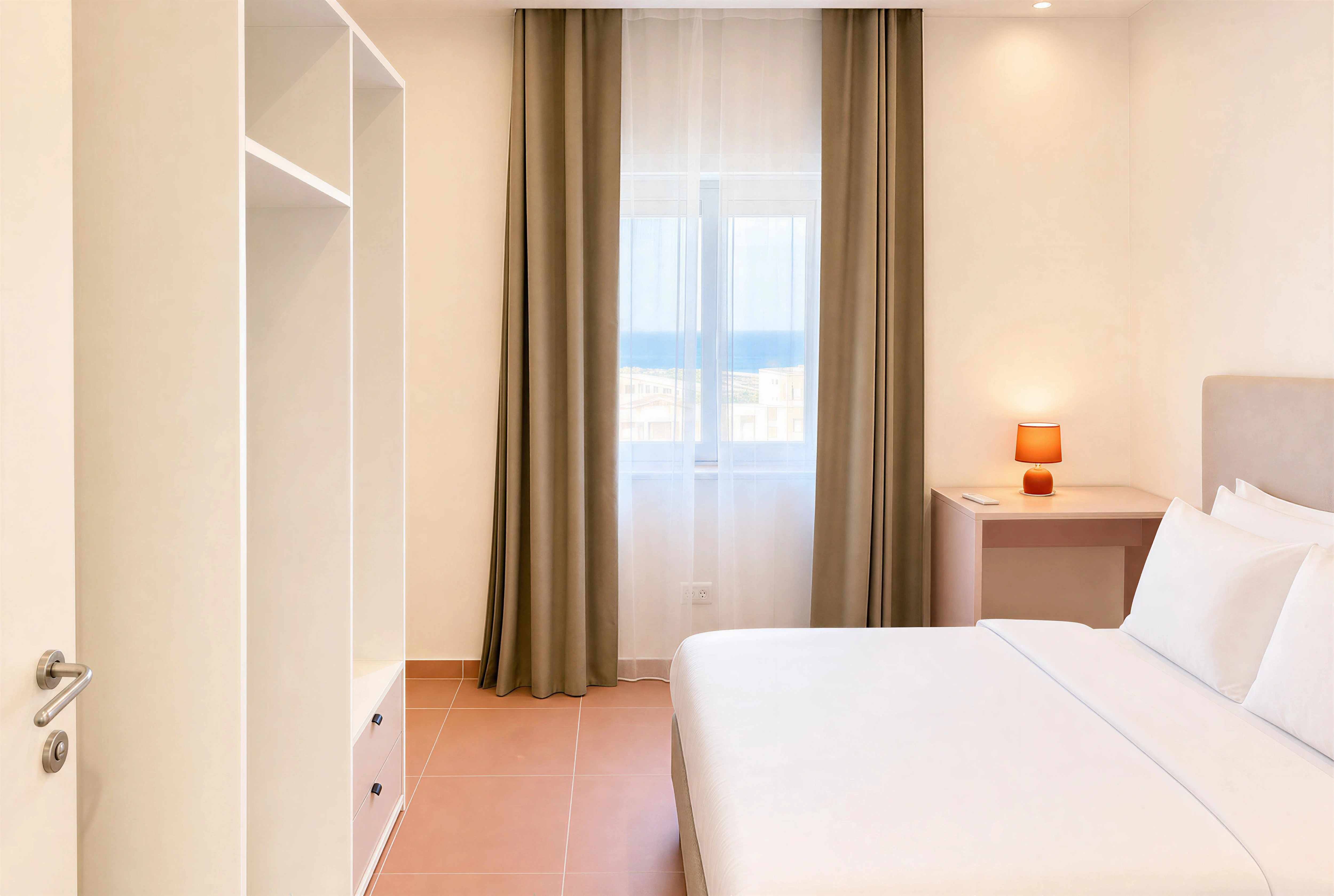 Twin bedroom with pink drawer unit and cream headboard in a 2-bedroom Flamingo apartment